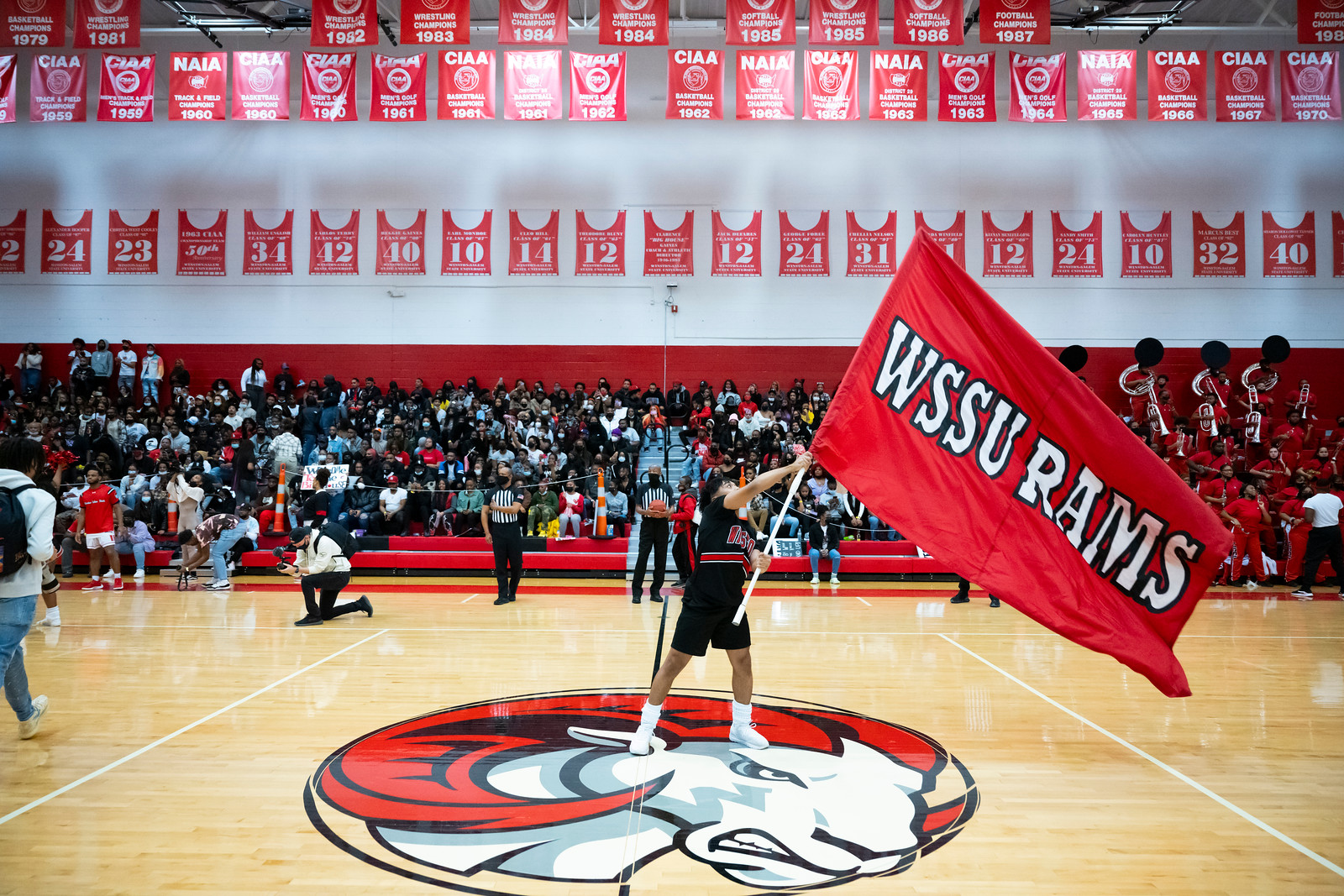 basketball game, student waving WSSU flag 